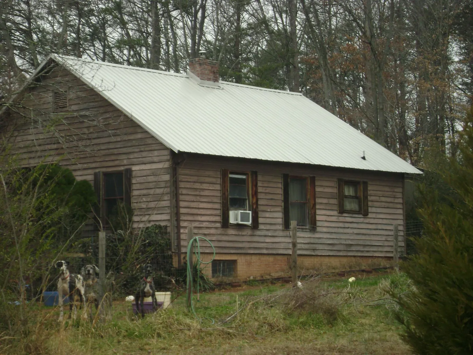White metal roof on an old wood sided farmhouse, from a Metal Roof Installation job in Jewett City
